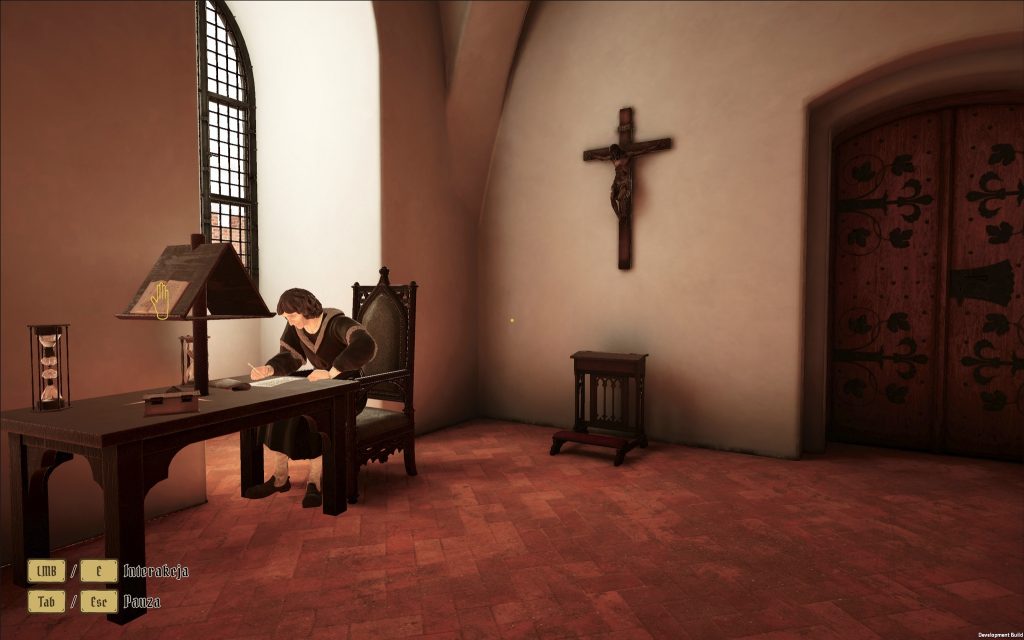 Mężczyzna pisze przy biurku w pokoju.